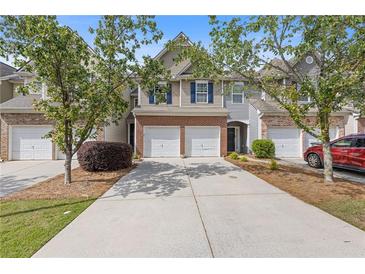 Charming townhome featuring a two-car garage, brick accents, and well-maintained landscaping in a desirable community at 2280 Baker Station Dr, Acworth, GA 30101
