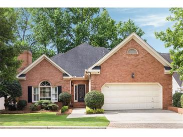 Charming brick home featuring a two-car garage, manicured landscaping, and a classic design at 1887 Chamdun Pl, Brookhaven, GA 30341