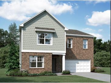 Two-story home showcases brick and shingle exterior, front yard, and attached garage at 7791 Sudbury Cir, Covington, GA 30014