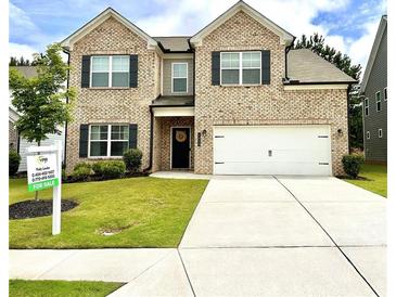 Charming two-story brick home with a well-manicured lawn and a two-car garage at 1452 Weatherbrook Cir, Lawrenceville, GA 30043
