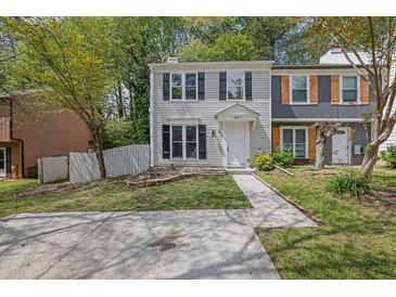 Charming two-story townhome with a well-manicured front yard and inviting entrance at 3571 Kennesaw Station Nw Dr, Kennesaw, GA 30144