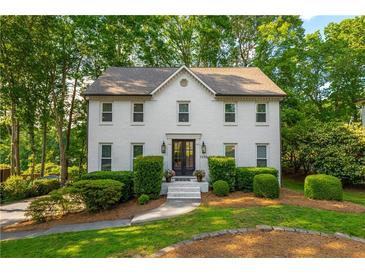 Charming two-story home with a landscaped front yard and classic white brick facade at 1590 Greyson Rdg, Marietta, GA 30062