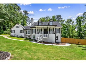 Charming two-story home with a inviting front porch and a well-manicured lawn at 1384 Sunrise Way, Lawrenceville, GA 30046
