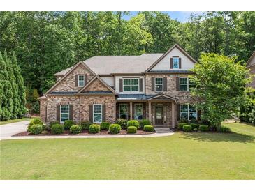 Charming two-story brick home featuring a well-manicured lawn and professional landscaping at 3230 Sundew Nw Dr, Acworth, GA 30101