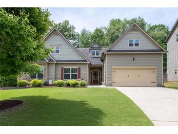 Charming two-story home featuring a well-manicured lawn and an attached two-car garage at 4690 Hopewell Manor Dr, Cumming, GA 30028