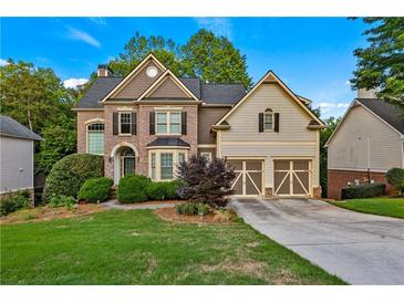Charming two-story home with a well-manicured lawn and a two-car garage at 6217 Millstone Trl, Douglasville, GA 30135