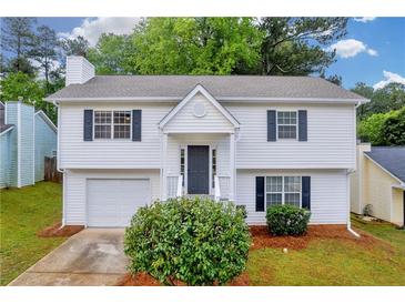Charming two-story home with white siding, black shutters, and well-manicured lawn at 1645 Cobbs Creek Ln, Decatur, GA 30032