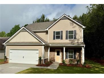 Charming two-story home with neutral siding, stone accents, and an attached two-car garage at 48 Beaver Pt, Villa Rica, GA 30180