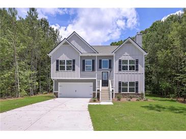 Charming two-story home featuring a two-car garage and inviting front porch at 48 Deer Pl, Villa Rica, GA 30180