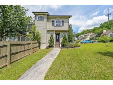 Inviting two-story home featuring well-manicured lawn and beautiful landscaping in a suburban neighborhood at 900 Mill Stone Dr, Marietta, GA 30062