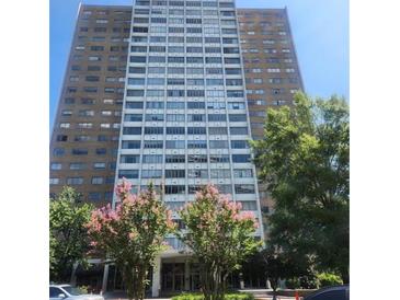 Beautiful high-rise building featuring brick and white siding, with many windows, set in a lovely landscaped area at 215 Piedmont Ne Ave # 507, Atlanta, GA 30308