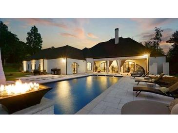 Inviting backyard featuring a luxurious pool, fire pit, lounge chairs, and covered outdoor seating area at , Buford, GA 30518