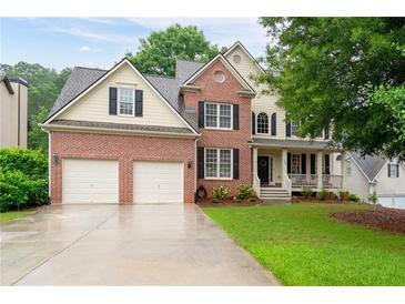Charming two-story brick home with a well-manicured lawn and attached two-car garage at 138 Knightwood Pt, Acworth, GA 30101