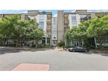 Modern condo building exterior with trees, street view, and covered parking at 3400 Malone Dr # 303, Atlanta, GA 30341