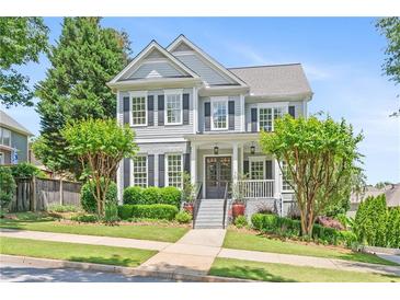 Charming two-story home with a manicured lawn, beautiful shrubbery, and a welcoming entrance with double doors at 1974 Mason Mill Rd, Decatur, GA 30033