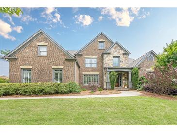 Beautiful two-story brick home with a manicured front lawn and stone accents at , Cumming, GA 30041