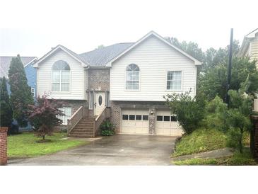 Charming two-story home boasts a brick-accented facade, symmetrical design, and a well-maintained front yard at 585 Station View Run, Lawrenceville, GA 30043