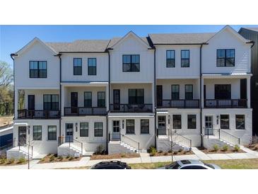 Charming townhomes featuring white exteriors, black trim, and inviting front porches at 1429 Hazy Way # 309, Atlanta, GA 30315