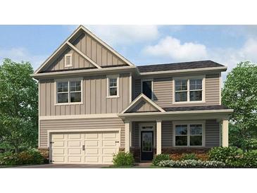 Charming two-story home featuring a neutral color palette, inviting front porch, and attached two-car garage at 2709 Montie Ct, Lithia Springs, GA 30122