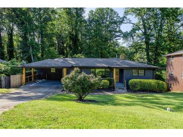 Charming single-story home with a covered carport, fresh landscaping, and a lush green lawn at 3193 Trasher Cir, Decatur, GA 30032