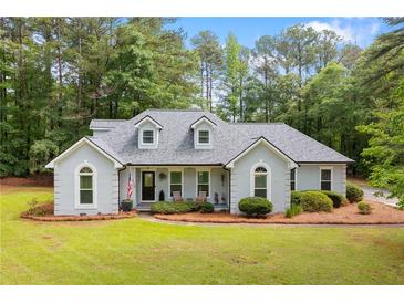 Charming single-story home with a well-manicured lawn, lush landscaping, and inviting curb appeal at 836 Palmetto Tyrone Rd, Sharpsburg, GA 30277