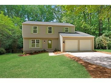 Charming two-story home with a well-maintained lawn, complemented by fresh landscaping and a convenient two-car garage at 4368 Heritage Glen Ct, Marietta, GA 30068