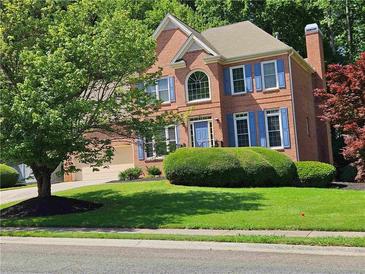 Charming two-story brick home with a well-manicured lawn and lovely blue shutters at 1270 Heritage Lakes Dr, Mableton, GA 30126