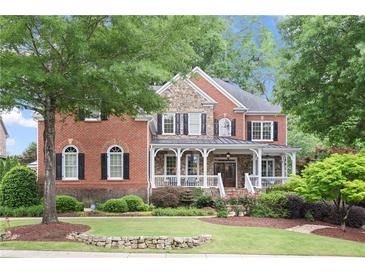 Charming two-story brick home featuring a welcoming front porch and beautifully landscaped front yard at 2630 Weddington Ne Pl, Marietta, GA 30068