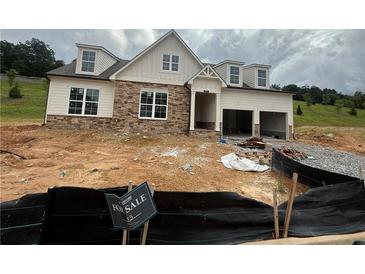Charming two-story home with stone accents, dormer windows, and an attached two-car garage at 313 Willow Cv, Canton, GA 30114