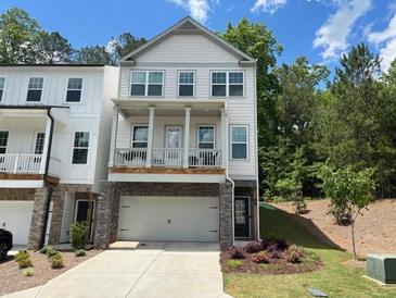 Charming two-story home featuring a covered porch and an attached two-car garage at 507 Bishop Ln, Woodstock, GA 30188