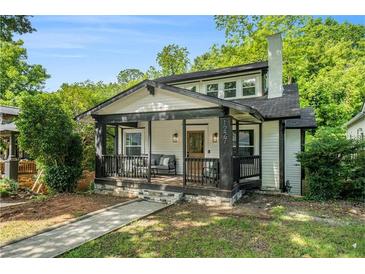 Charming home with a cozy front porch, stone foundation and a manicured lawn at 1227 Epworth Sw St, Atlanta, GA 30310
