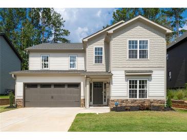 Charming two-story home features a two-car garage and beautifully landscaped front yard at 2428 Mills Bnd, Decatur, GA 30034