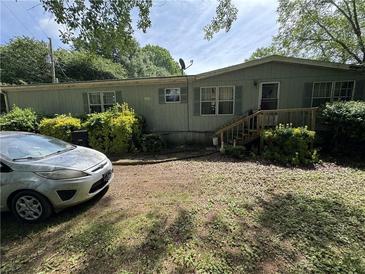 Charming home featuring a covered porch, well-maintained landscaping, and a welcoming facade at 6722 Heardsville Rd, Cumming, GA 30028