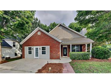 Charming single-story home featuring a brick facade, attached garage, and a welcoming front porch at 700 Patriots Point St, Locust Grove, GA 30248