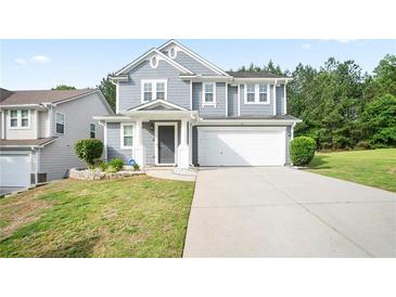 Inviting two-story home with a well-maintained lawn, a two-car garage, and classic curb appeal at 2210 Valley Creek Dr, Lithia Springs, GA 30122