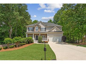 Charming two-story home with a well-maintained lawn, two-car garage, and inviting front porch at 84 Conner Glenn Dr, Hiram, GA 30141