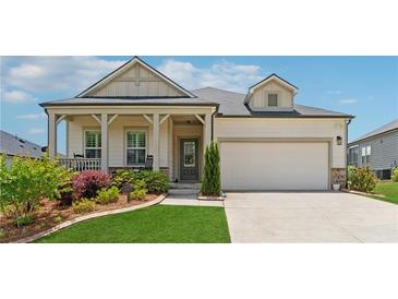 Charming single-Gathering home with a manicured lawn, covered porch, and two-car garage at 1061 Towne Mill Xing, Canton, GA 30114