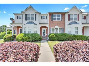 Inviting townhome featuring a well-manicured lawn and appealing architectural details at 7120 Oakley Ct, Union City, GA 30291