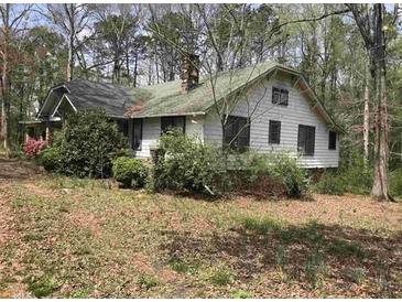 Traditional home exterior with mature trees offering shade and privacy at 650 Sage St, Temple, GA 30179
