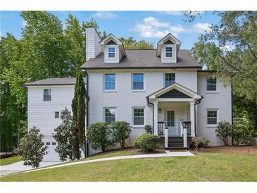 Charming two-story home with a painted white brick facade and a well-maintained lawn at 2506 Octavia Ln, Marietta, GA 30062