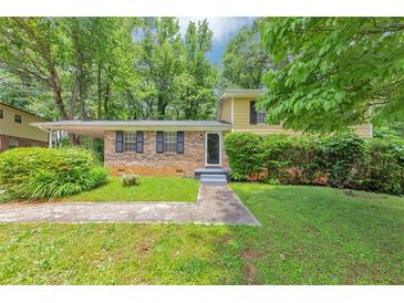 Charming home with brick facade, manicured landscaping, and a covered carport at 3900 Bressler Cir, Decatur, GA 30035
