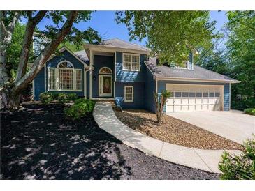 Charming blue two-story home with manicured front yard and inviting walkway at 4915 Bayberry Dr, Cumming, GA 30040