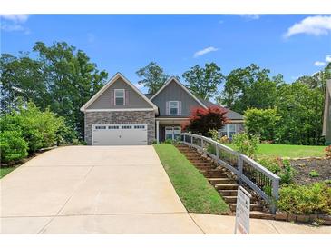 Charming two-story home with stone accents, a two-car garage, and landscaped front yard at 114 Brookstone Dr, Carrollton, GA 30116