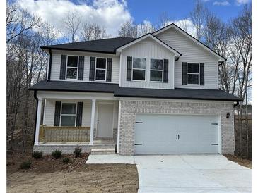 Charming two-story home featuring a brick facade, white siding, and a spacious two-car garage at 528 Earnest Ln, Temple, GA 30179