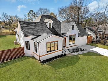 Charming home with a well-manicured lawn and a newly installed horizontal fence at 1774 Vesta Ave, Atlanta, GA 30337