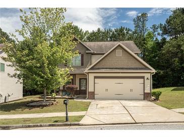 Charming two-story home featuring a two-car garage and a well-manicured front yard with mature landscaping at 856 Donington Cir, Lawrenceville, GA 30045