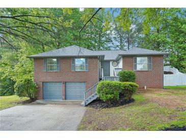 Charming brick home with a two-car garage, landscaped front yard, and inviting entrance at 4787 Burford Nw Ct, Acworth, GA 30102