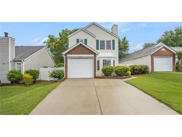 Charming two-story home featuring a brick-accented garage and manicured lawn at 3979 White Owl Nw Ct, Duluth, GA 30097