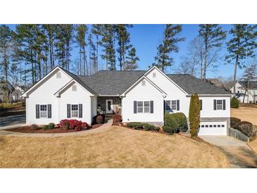 Beautiful single-story home with manicured front lawn, enhanced by the well-kept landscaping and charming details at 6218 Old Stilesboro Nw Rd, Acworth, GA 30101
