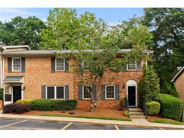 Charming brick townhouse with well-maintained landscaping and dark shutters at 111 Northdale Pl, Lawrenceville, GA 30046